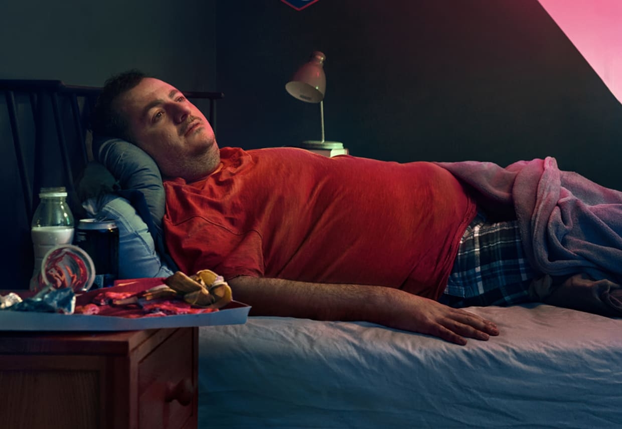 Man laying in a bed. Actor portrayal.